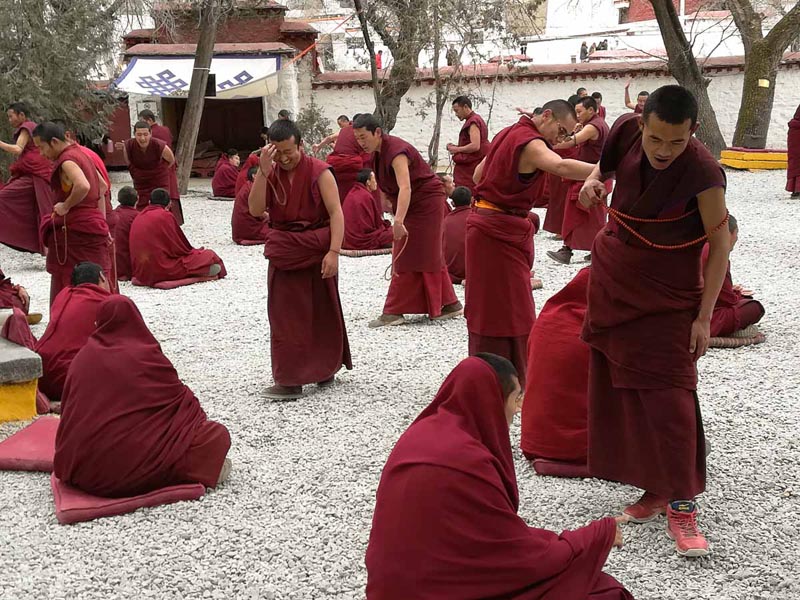 monks debating Buddhism in Tibet monastery