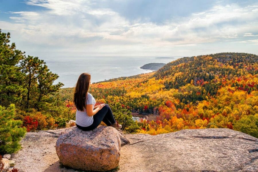 Girl at the summit of the Beehive Trail in Acadia National Park